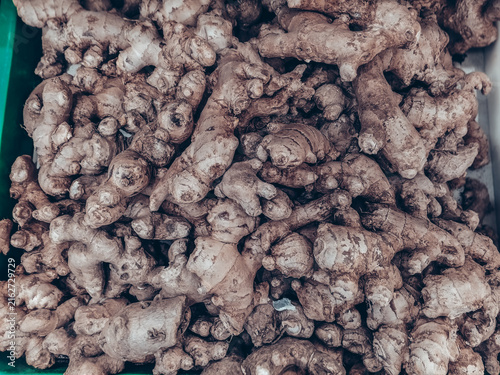 Fotografie Full frame view of stacked fresh ginger roots rhizomes with rustic earthy textur