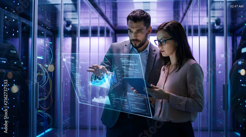 Obraz na płótnie Tech Team Analyzing Data in Futuristic Server Room Environment