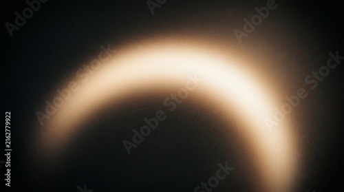 Abstract Golden Solar Eclipse Crescent Light In Blurred Dark Sky