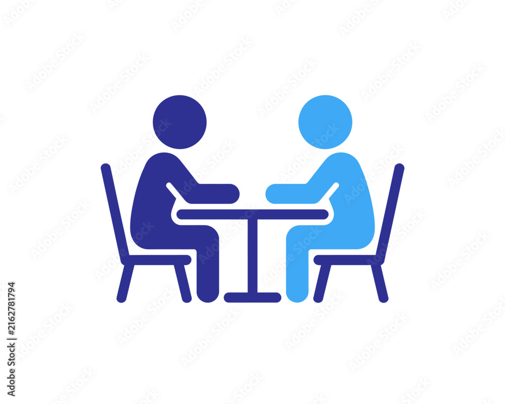Fototapeta premium Two people sitting at a table having a conversation