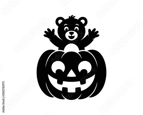 Obraz na plátne Cute teddy bear sitting inside a carved halloween pumpkin jackolantern