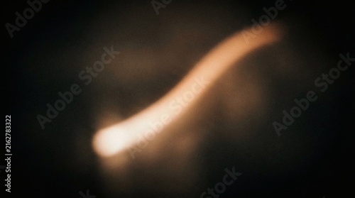 Abstract Golden Light Trail With Soft Glowing Bokeh Effect On Dark Background For Elegant Cinematic Background Design