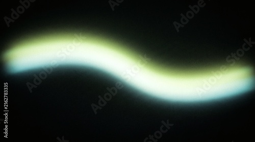 Abstract Glowing Neon Green Wavy Light Trail On Black Background For Modern Minimalist Design And Digital Wallpaper