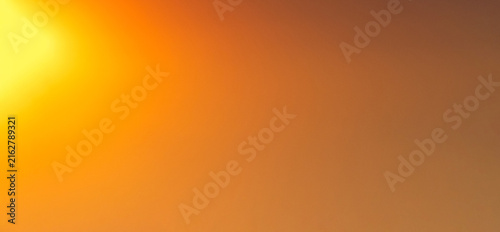 Fotografie Smooth warm orange and yellow gradient background featuring a luminous blurred g