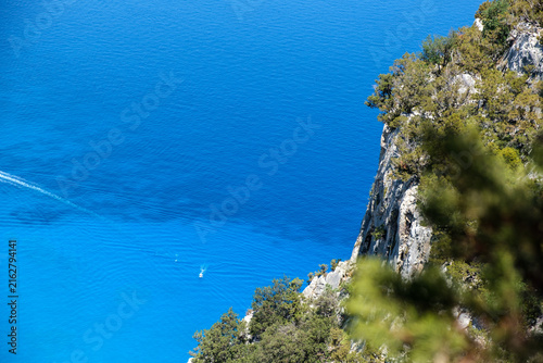 aerial closeup on the amazing water colours of Cala Goloritze, Orosei, with mediterranean shrubs, world's number one beach, outdoors, trekking, sailing, swimming, 