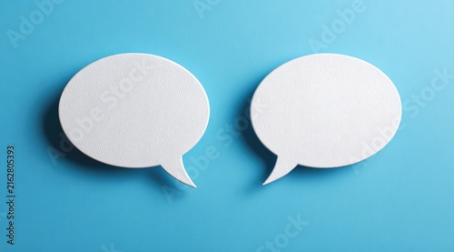 Two white speech bubble cutouts, rendered on a vibrant blue background, suggesting dialogue