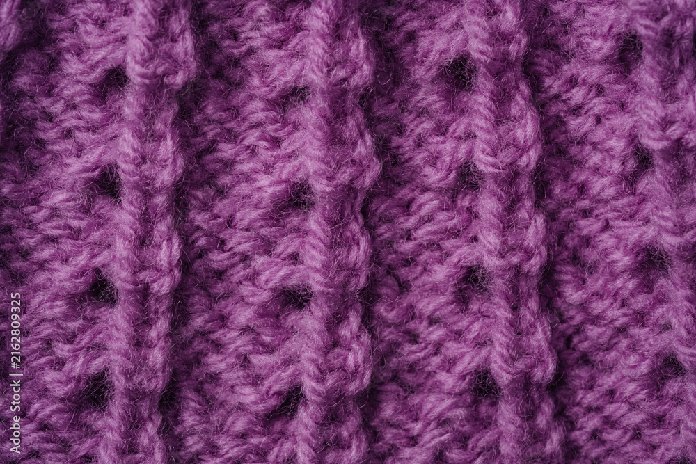 Fototapeta premium Purple knitted fabric with open stitch pattern background