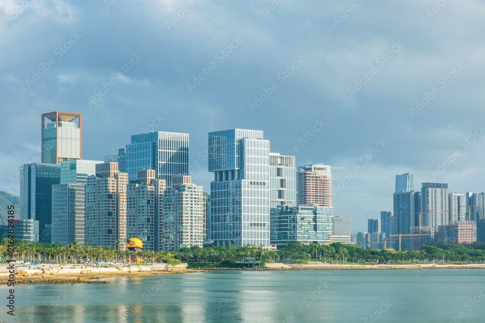 Fototapeta premium Modern waterfront district with contemporary high rise buildings and green public space in Shenzhen city, China. Urban landscape, business development, modern infrastructure, economic growth