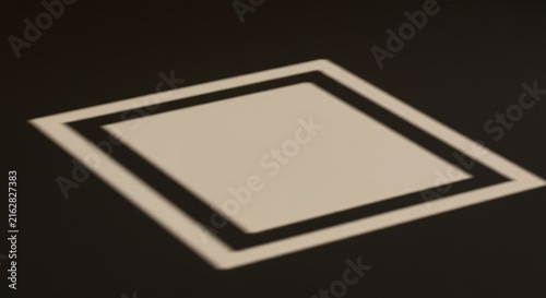 A geometric shadow projection casts a stark, empty rectangular space onto a smooth, textured surface, serving as a conceptual placeholder for design elements ,stage ,space ,minimalist