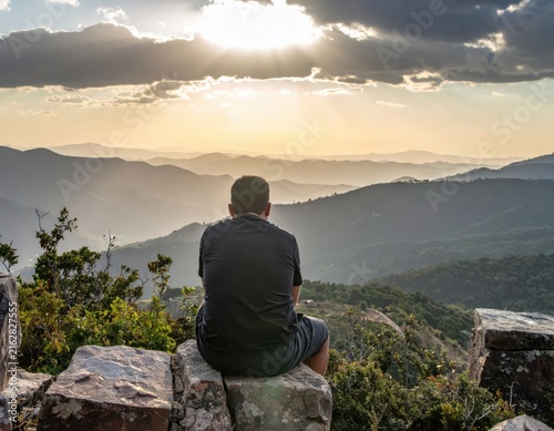 Peaceful Solo Moment in Nature with Mountain View and Beautiful Sunset Over the Horizon