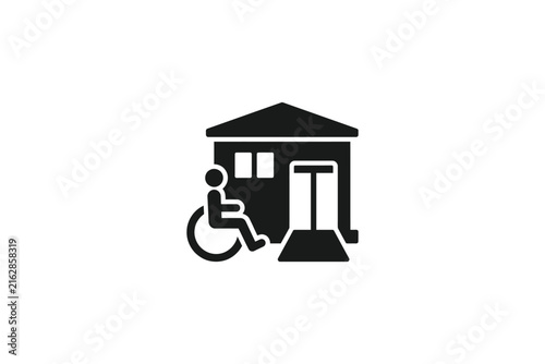 Black icon of a house with a wheelchair user and ramp for accessibility.