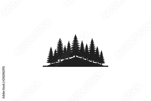 Silhouette of a dense forest of pine trees on a hill.