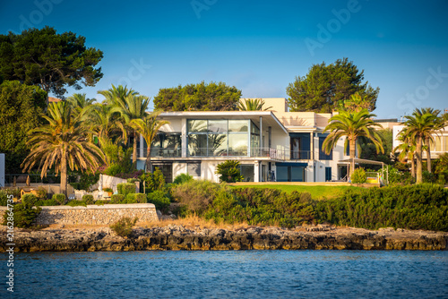 Obraz na plátně A modern luxurious seafront property located in Mallorca, Spain, with contemporary design, big glass windows