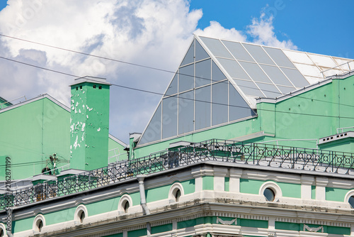 Cuadro en lienzo Weathered chimney and ornate cornice on a historic green building roof