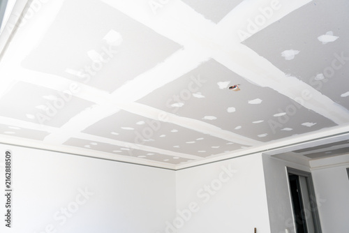 Konstfotografi Plasterboard ceiling with taped joints under renovation
