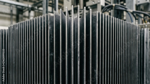 Close up of a large industrial metal heat sink with many fins.