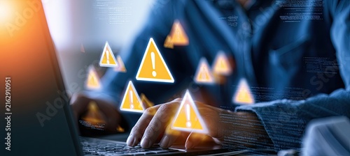 Cybersecurity Warning Alerts on Laptop Screen with Person Typing.