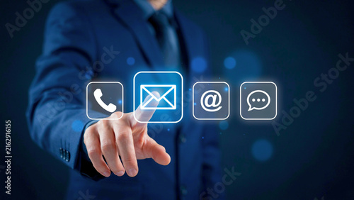Businessman touching contact us digital icons for customer support and communication technology concept