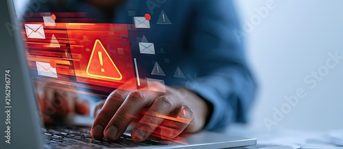Cybersecurity alert warning on laptop screen with digital data and email icons.