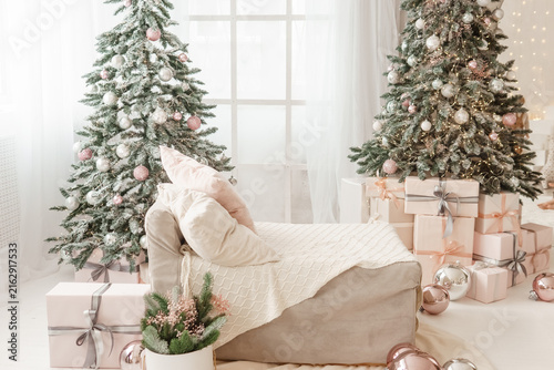 Canvastavla Christmas interior with two decorated trees, glowing lights, wrapped presents, and cozy armchair