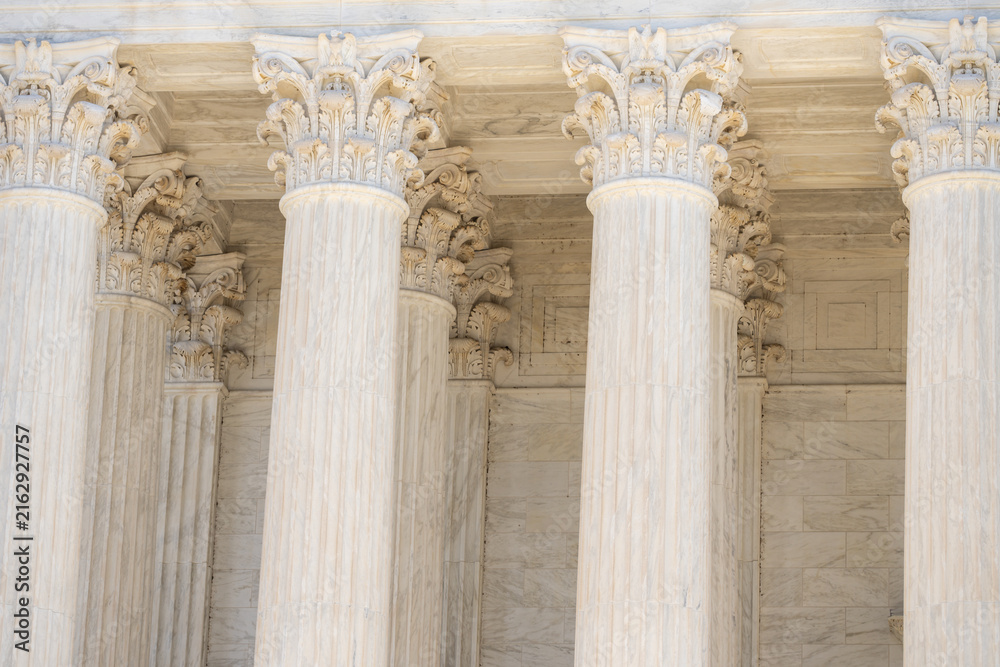 Obraz premium Marble pillars highlight timeless architecture. Historic government building with massive columns. Classical facade with elegant stone pillars. Court house exterior with refined architecture.
