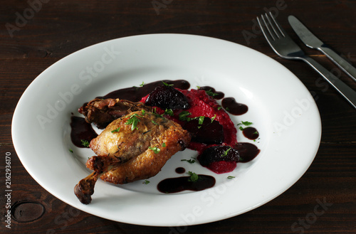 Crispy roasted duck leg served with beetroot puree and dark reduction sauce