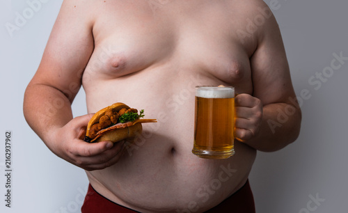 Fotografie Beer belly shows overweight man