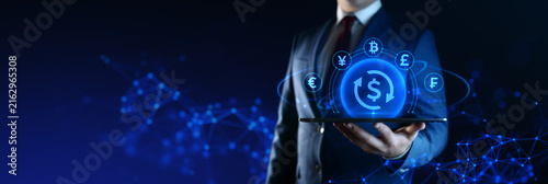 Businessman holding tablet with Currency Exchange icons on screen. Business and Finance concept