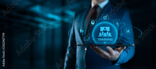 Businessman Holding tablet with Training Icons on Screen. E-Learning and online Education concept