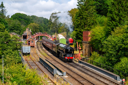 Fotografie A historic steam train at the Goathland station on its journey from Whitby to Pi