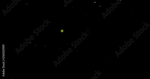 Abstract yellow glowing stars floating and twinkling against a dark background stock video