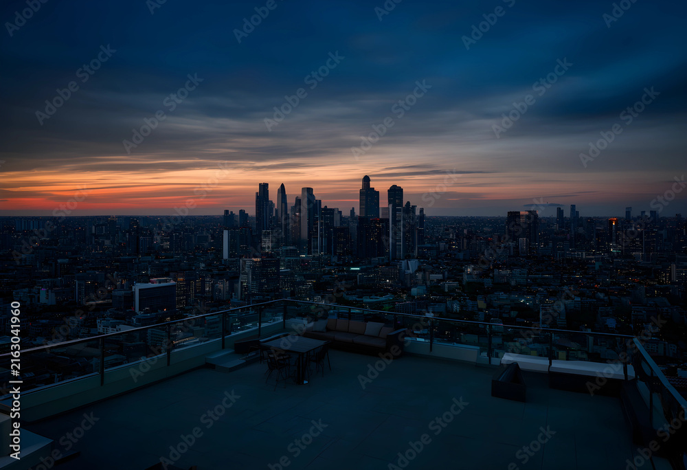 Fototapeta premium Urban skyline at sunset, city life and modern architecture, rooftop view with dramatic sky and illuminated buildings