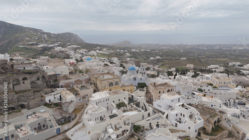 Aerial view of the historic village of Pyrgos Kallistis with its traditional white-washed buildings, blue-domed churches, and winding streets on the hillside in Pyrgos Kallistis, Greece.