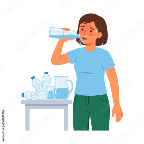 Fotografie A thirsty woman drinking water from a plastic bottle to quench her extreme heat