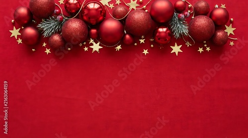 Christmas background with red ornaments and golden stars on red surface