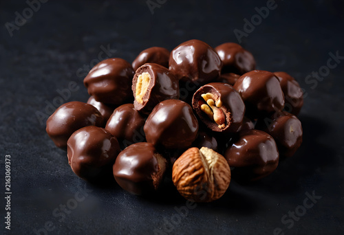 Chocolate covered hazelnuts gourmet dessert and sweet snack confectionery and indulgence dark background food photography