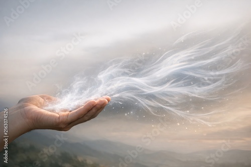 A person holding a white feather in their hand