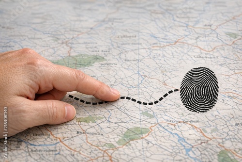 A finger is pointing to a unique identifier on a map, representing a search for something specific