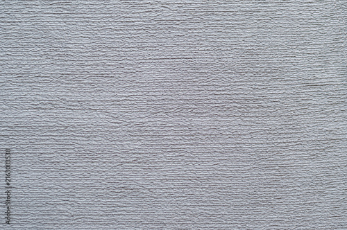 Close-up texture of grey crinkle crepe fabric, abstract soft ribbed textile background