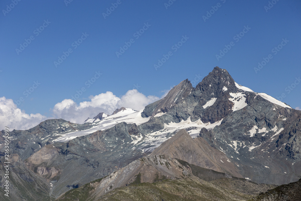 Obraz premium Spektakuläre Hochgebirgslandschaft mit schroffen Gipfeln und alpinem Bergsee