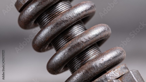 Close-Up of Rusty Metal Coil Spring with Detailed Texture and Patterns
