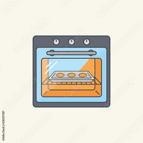 Modern kitchen oven appliance with a tray of fresh baked cookies inside for culinary baking and food preparation activities