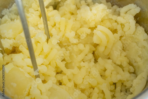 Photography Making mash potato with hand potato masher