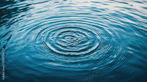 Concentric water ripples on deep blue surface with smooth circular motion patterns