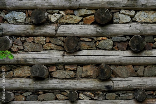 Obraz na plátne A retaining wall made of logs and natural stone