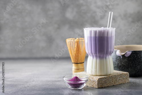 Ube latte in glass. Healthy vegan drink. Viral trendy asian beverage