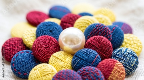 Buttons of Red Yellow and Blue Fabric with a Centered White Pearl