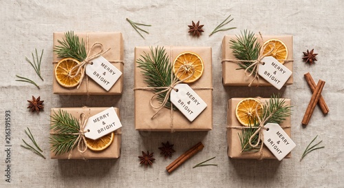 Eco friendly Christmas gift boxes wrapped in craft paper with orange slices and pine needles