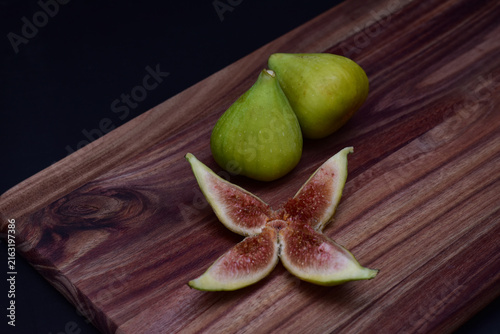 Fresh figs and a sliced fig on a charcuterie board