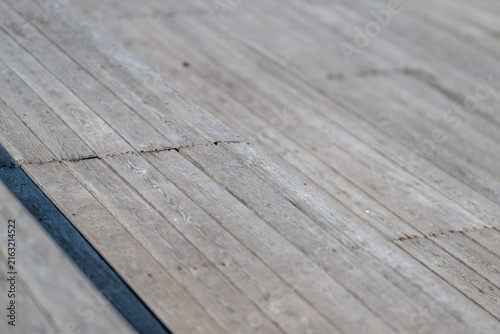 Cuadro en lienzo Weathered wooden planks glimmer in the sunlight revealing textures and stories o